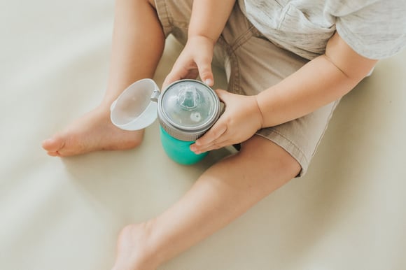 toddler holding baby sippy cup product
