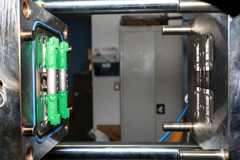 Green Baby Brushies Toy in Molding Machine